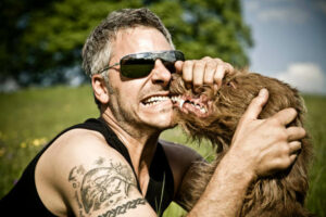 Man with Dog Both Snarling Teeth and Growling